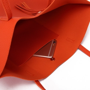 Detail view showing orange litchi texture PU leather interior and magnetic snap closure