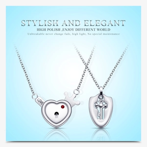 Polished silver stainless steel couple necklace set featuring heart lock and key pendants