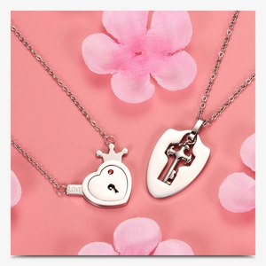 Detail of silver stainless steel heart lock and key necklaces with red zircon and love engraving