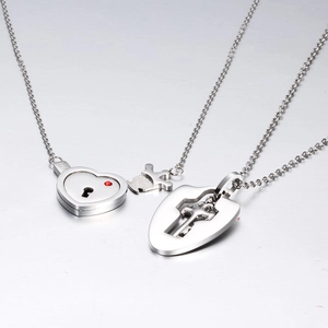 Stainless steel couple necklaces featuring a heart lock with red crystal and cross key pendants