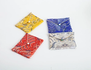 Detailed view of colorful brocade jewelry pouches with traditional Chinese patterns