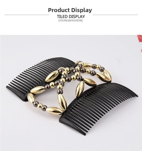 Detail view of double beaded magic hair comb with gold and black beads on white background