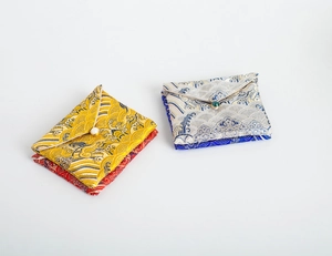 Detail of silk brocade jewelry pouches with pearl buttons and traditional wave patterns