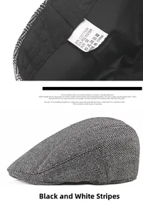 Detail of black and white herringbone flat cap showing fabric tag and side profile