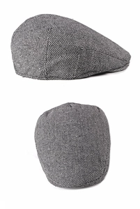 Detail view of grey herringbone flat cap showing classic texture and woven wool fabric