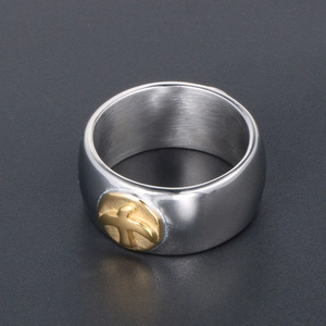 Minimalist titanium steel wide ring featuring a gold flying bird crest on dark background