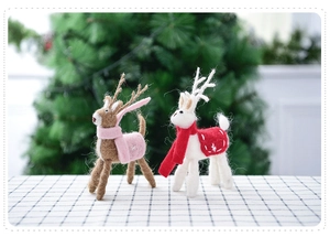 Detailed texture of handmade wool felt reindeer figurines with festive Christmas scarves