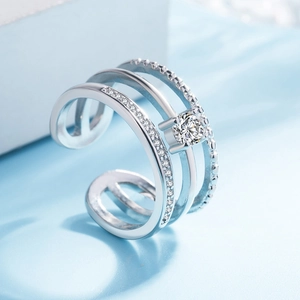 Macro shot of a three-layer silver ring with sparkling diamonds and an open adjustable band