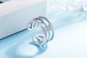 Macro shot of silver triple-layered open ring with sparkling crystal inlay details