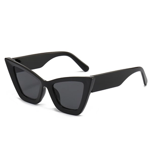 Fashionable oversized cat-eye sunglasses with glossy black frames and dark lenses