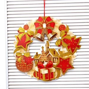 3D paper Christmas wreath with red bow, gold bells and stars on white wooden background