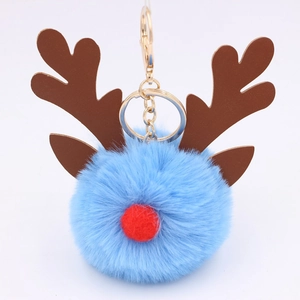 Close-up of light blue Christmas reindeer pom pom keychain with golden metal hook