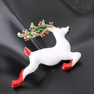 Detail of running reindeer brooch with white enamel, red rhinestones and green antlers