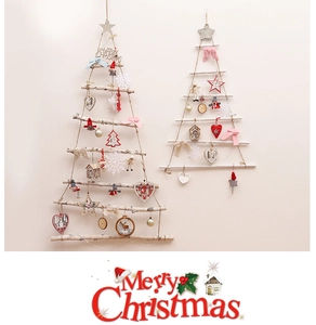Detail of DIY hanging wooden branch Christmas tree with ornaments and star topper
