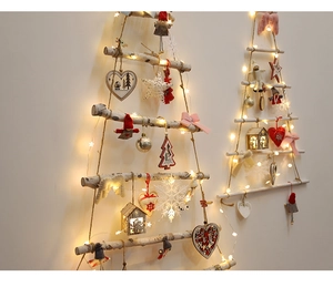 Detail of wooden wall hanging Christmas tree with warm LED lights and felt ornaments