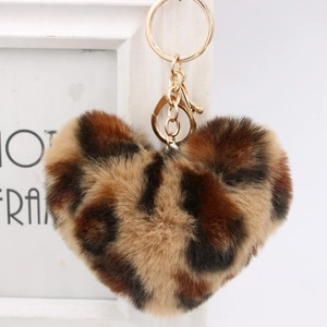 Macro shot of fluffy leopard print heart plush keychain with golden metal clasp