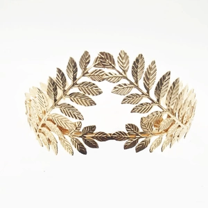 Detailed view of golden laurel leaf crown featuring intricate texture and metallic finish
