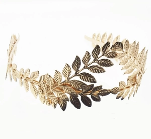 Macro shot of detailed golden leaf texture on baroque style metallic laurel crown