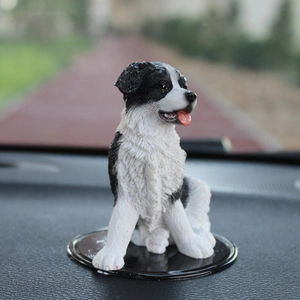 Realistic Border Collie puppy car dashboard ornament with black base and textured fur detail