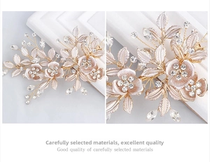 Detail of handmade gold floral bridal hair clip with crystal beads and white leaf accents