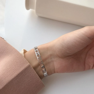 Polished S925 sterling silver open bangle featuring hollow Roman numeral design for women