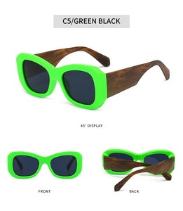 Detail view of green chunky sunglasses featuring brown wood-grain textured temples