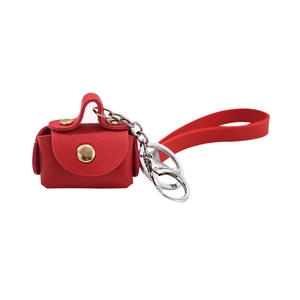 Mini red PU leather pouch keychain with gold buckle and a silicone wrist strap for keys