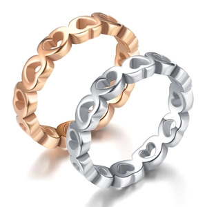 Detail of rose gold and silver hollow heart pattern rings in durable stainless steel