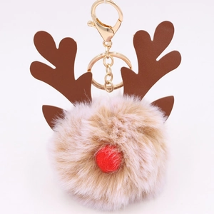 Close-up of reindeer plush pom pom keychain with khaki fur and red nose detail