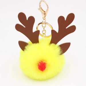 Detailed view of yellow plush reindeer keychain with golden metal ring and brown antlers