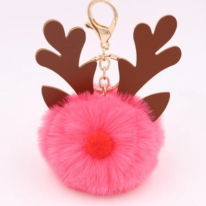 Detailed close-up of pink plush reindeer keychain with golden metal clasp and brown antlers