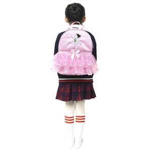 Rear view of a girl wearing a pink ballet backpack with tutu skirt and embroidery