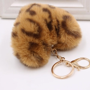 Close-up of heart-shaped leopard print faux fur keychain with gold lobster clasp