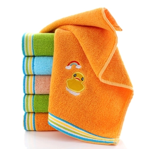 Stack of colorful soft cotton kids towels with cartoon duck and rainbow embroidery