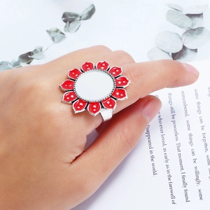 Close-up of red flower petal ring on finger with elegant minimalist artistic background