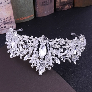 Macro detail of bridal silver tiara with crystal leaves on a vintage book