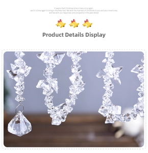 Macro detail of clear acrylic snowflake bead strand with faceted crystal teardrop pendant