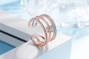 Macro shot of rose gold triple-layered ring featuring a central sparkling zircon stone