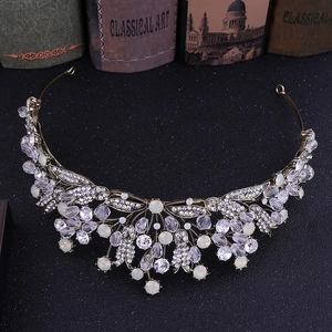 Close-up of Baroque gold leaf crown with clear rhinestones and opal-style gemstones