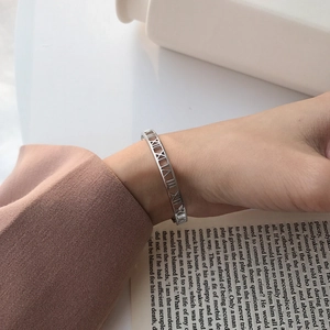 Detailed close-up of S925 silver cuff bracelet featuring hollow Roman numeral engravings