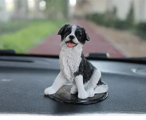 Detail of Border Collie car ornament with black and white fur on dashboard