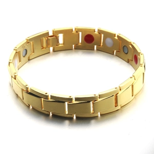 Detail of gold-plated copper health bracelet with red white and blue magnetic stones