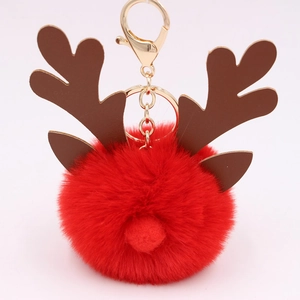 Detailed view of red plush Christmas reindeer keychain with gold metal clasp and brown antlers