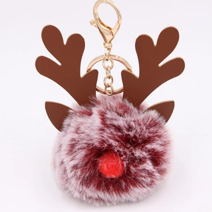 Detail of reindeer plush ball keychain with red nose and gold-tone lobster clasp
