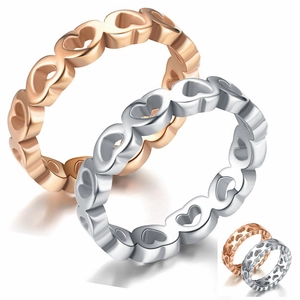 Detailed close-up of hollow heart pattern rings in rose gold and silver finishes
