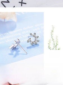 Close-up of silver windmill zircon stud earrings with rectangular crystal inlays