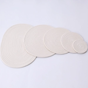 5-piece set of cream woven cotton heat resistant mats including oval and round shapes