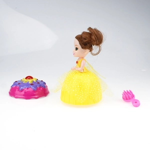 Close-up of a scented cupcake surprise doll with yellow glitter dress and pink mini hairbrush