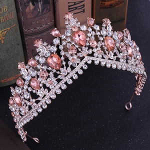 Detail of rose gold bridal tiara with pink crystals and rhinestones on vintage books