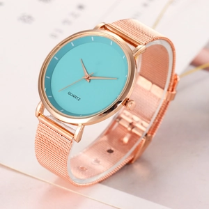 Detailed view of women's quartz watch with teal dial and rose gold mesh strap